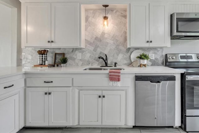 615 Ridgecrest Rd, Edmond, OK 73013 - kitchen featuring appliances with stainless steel finishes, a sink, white cabinetry, and light countertops