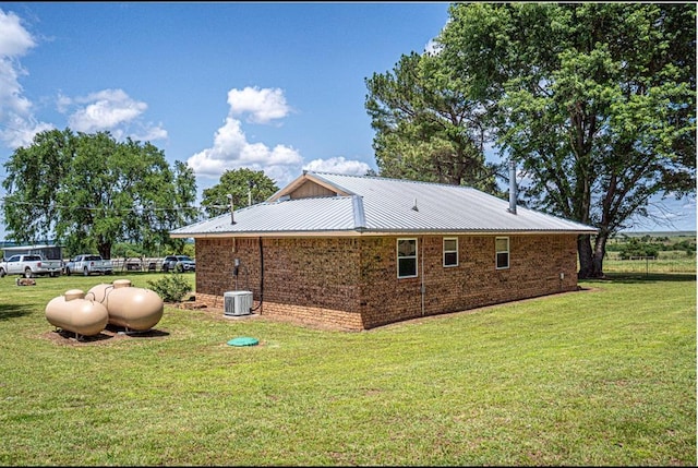 106049 N 3855-1 Rd, Weleetka, OK 74880 - view of home's exterior featuring a yard, brick siding, and metal roof