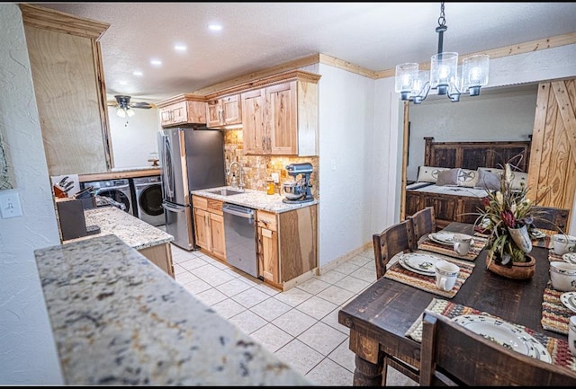 106049 N 3855-1 Rd, Weleetka, OK 74880 - kitchen featuring independent washer and dryer, appliances with stainless steel finishes, light tile patterned flooring, a chandelier, and tasteful backsplash