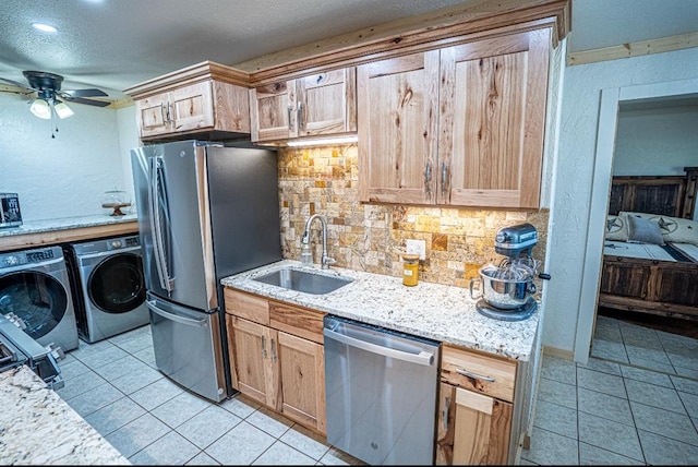 106049 N 3855-1 Rd, Weleetka, OK 74880 - kitchen featuring stainless steel appliances, independent washer and dryer, a sink, tasteful backsplash, and ceiling fan