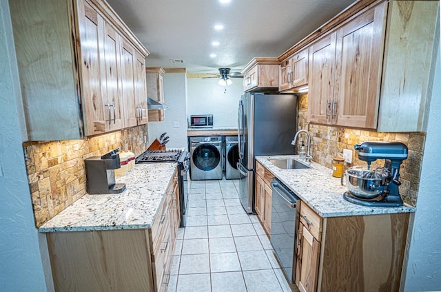 106049 N 3855-1 Rd, Weleetka, OK 74880 - kitchen featuring appliances with stainless steel finishes, washer and clothes dryer, a sink, tasteful backsplash, and a textured wall