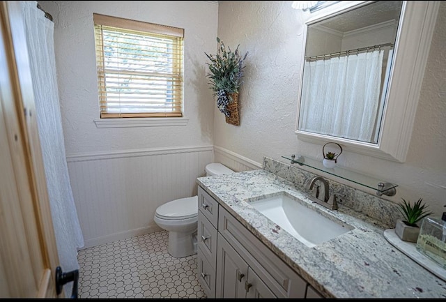 106049 N 3855-1 Rd, Weleetka, OK 74880 - full bathroom with toilet, vanity, a wainscoted wall, ornamental molding, and a textured wall