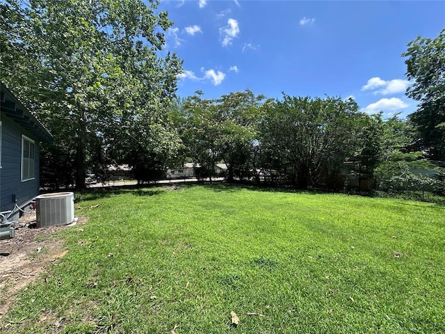 811 N Broadway St, Broken Bow, OK 74728 - view of green lawn with central air condition unit
