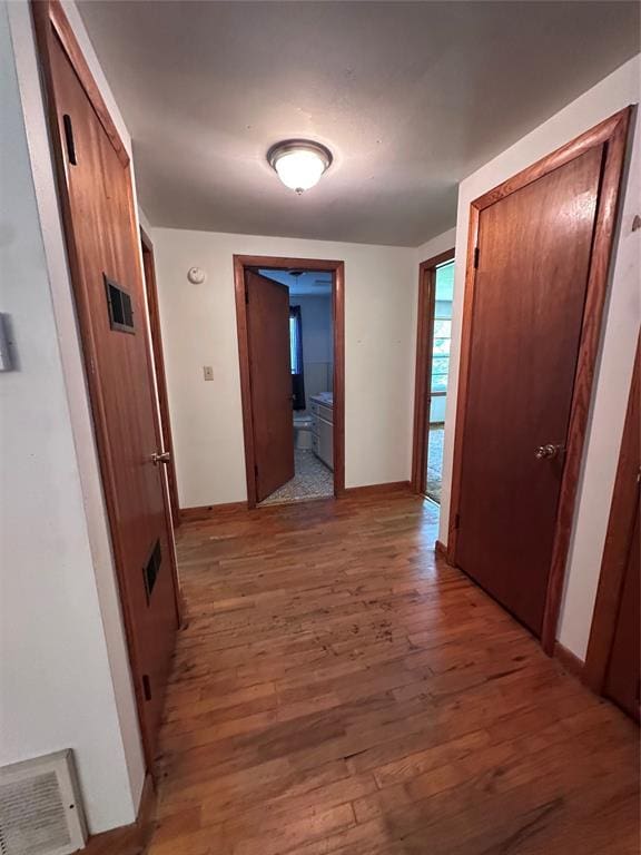 811 N Broadway St, Broken Bow, OK 74728 - hallway featuring wood finished floors and baseboards