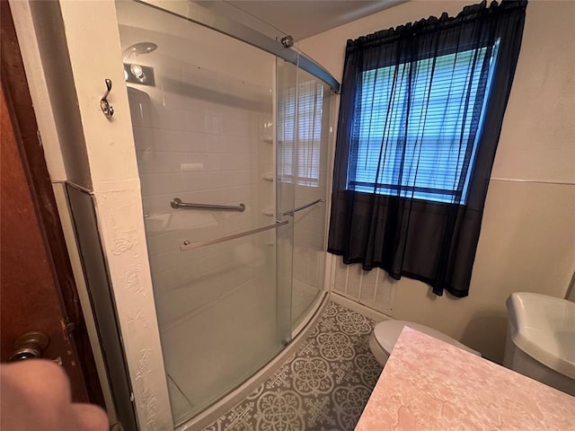811 N Broadway St, Broken Bow, OK 74728 - full bathroom with a stall shower, toilet, and tile patterned floors