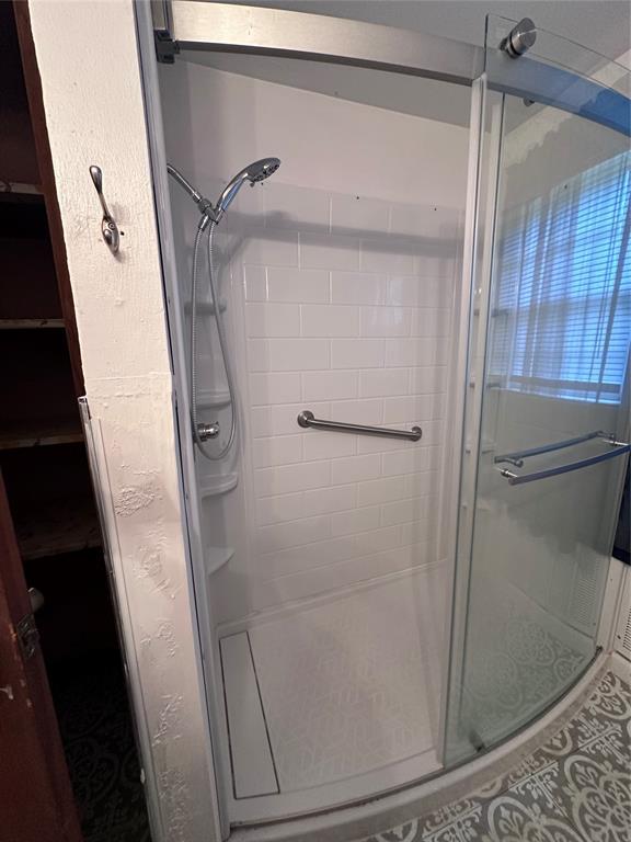 811 N Broadway St, Broken Bow, OK 74728 - full bath featuring a stall shower and tile patterned floors