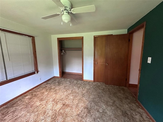 811 N Broadway St, Broken Bow, OK 74728 - unfurnished bedroom with carpet floors, two closets, baseboards, and a ceiling fan