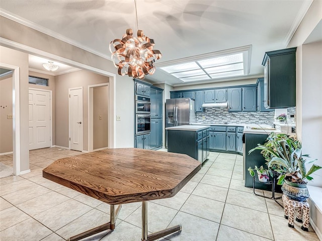 1320 Von Elm Pl, Yukon, OK 73099 - kitchen with blue cabinetry, a chandelier, light tile patterned flooring, light countertops, and decorative backsplash