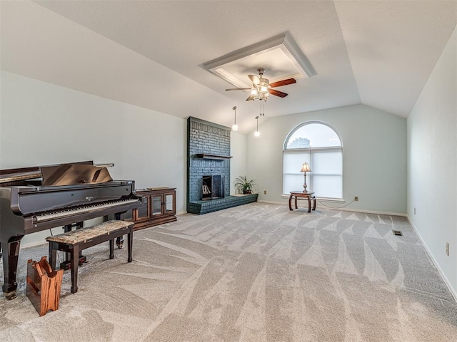 1320 Von Elm Pl, Yukon, OK 73099 - sitting room with vaulted ceiling, a ceiling fan, light carpet, a brick fireplace, and baseboards