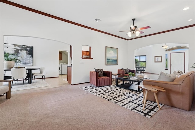 709 S Greengate Dr, Yukon, OK 73099 - living room featuring arched walkways, separate washer and dryer, light carpet, crown molding, and ceiling fan
