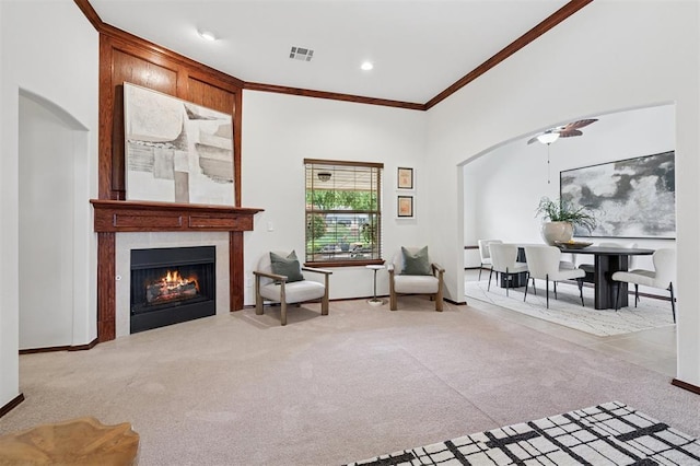 709 S Greengate Dr, Yukon, OK 73099 - sitting room with crown molding, arched walkways, carpet, a fireplace, and a ceiling fan