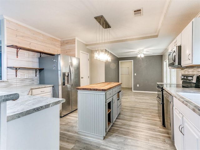 12325 Spring Meadows Rd, Yukon, OK 73099 - kitchen featuring open shelves, wooden counters, stainless steel appliances, light wood-style floors, and crown molding