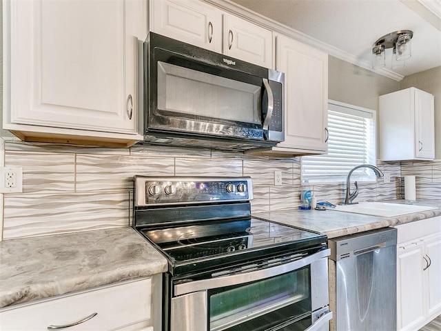 12325 Spring Meadows Rd, Yukon, OK 73099 - kitchen with stainless steel appliances, a sink, tasteful backsplash, white cabinetry, and light countertops