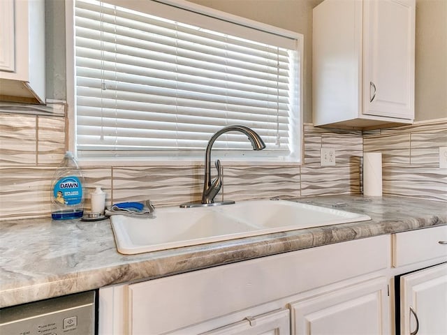 12325 Spring Meadows Rd, Yukon, OK 73099 - kitchen view of a sink, backsplash, light countertops, white cabinets, and stainless steel dishwasher