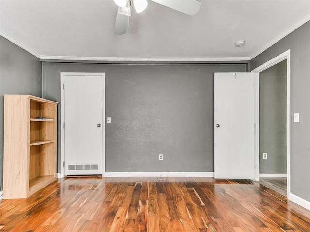12325 Spring Meadows Rd, Yukon, OK 73099 - empty room featuring crown molding, wood finished floors, ceiling fan, baseboards, and a smoke detector