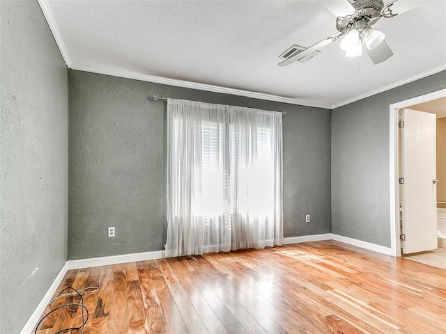 12325 Spring Meadows Rd, Yukon, OK 73099 - empty room featuring a textured wall, ornamental molding, a ceiling fan, wood finished floors, and baseboards