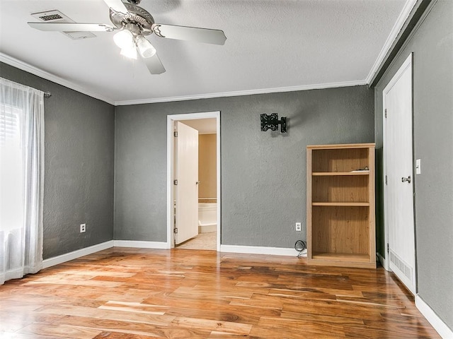 12325 Spring Meadows Rd, Yukon, OK 73099 - unfurnished room with a textured wall, crown molding, wood finished floors, a ceiling fan, and a textured ceiling