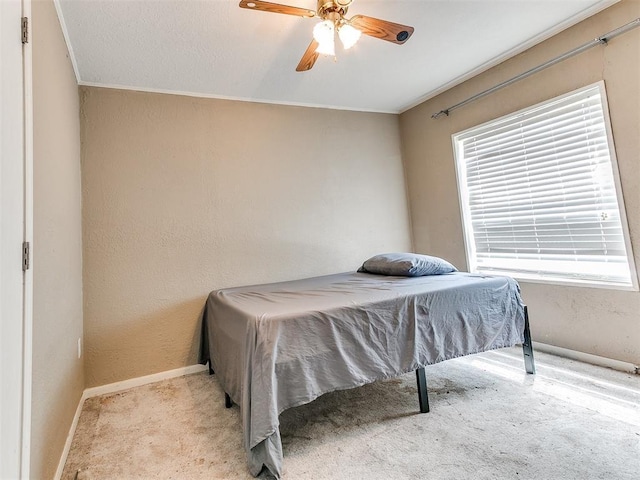 12325 Spring Meadows Rd, Yukon, OK 73099 - carpeted bedroom featuring multiple windows, baseboards, crown molding, a ceiling fan, and a textured wall