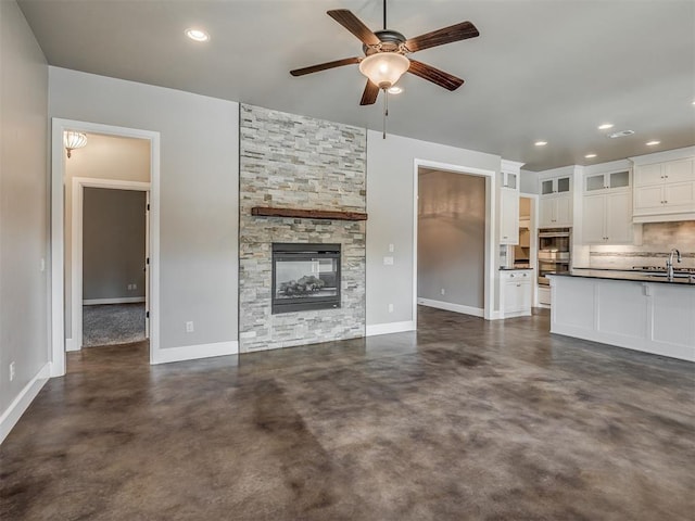 5021 SE 12th Ave, Washington, OK 73093 - unfurnished living room featuring concrete flooring, ceiling fan, a fireplace, and recessed lighting