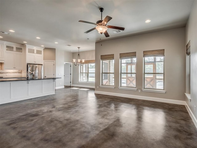 5021 SE 12th Ave, Washington, OK 73093 - unfurnished living room featuring concrete flooring, a ceiling fan, a chandelier, and recessed lighting