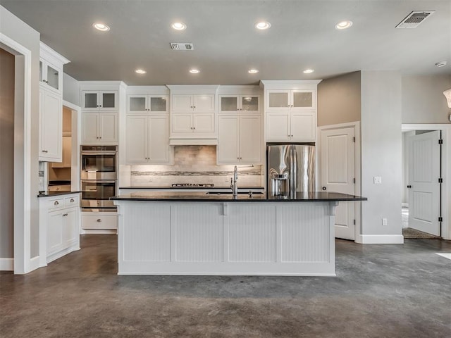 5021 SE 12th Ave, Washington, OK 73093 - kitchen with stainless steel appliances, concrete floors, backsplash, dark countertops, and recessed lighting