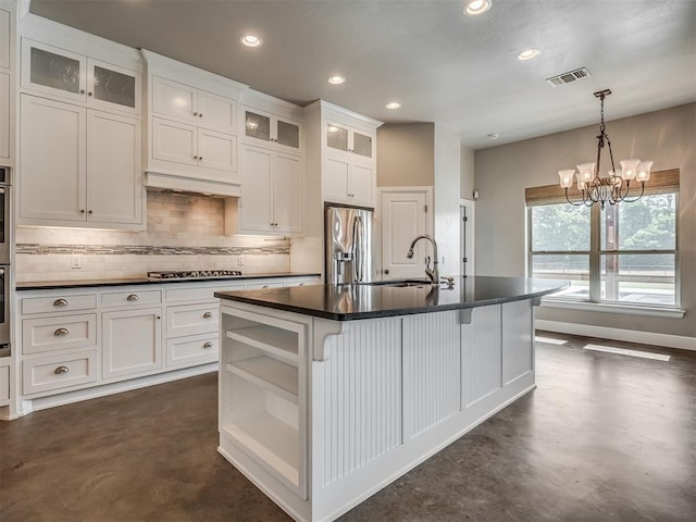 5021 SE 12th Ave, Washington, OK 73093 - kitchen featuring appliances with stainless steel finishes, concrete floors, dark countertops, tasteful backsplash, and white cabinetry