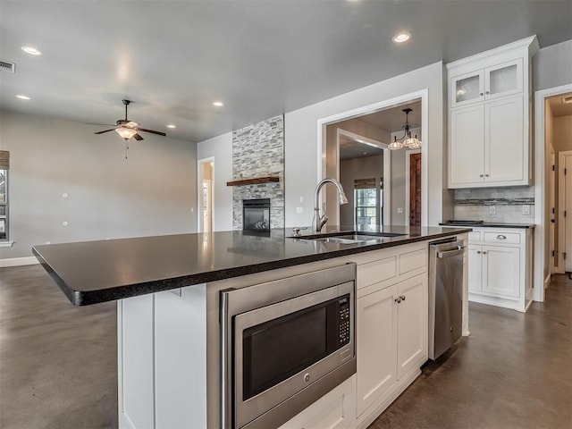 5021 SE 12th Ave, Washington, OK 73093 - kitchen with appliances with stainless steel finishes, finished concrete floors, open floor plan, dark countertops, and recessed lighting