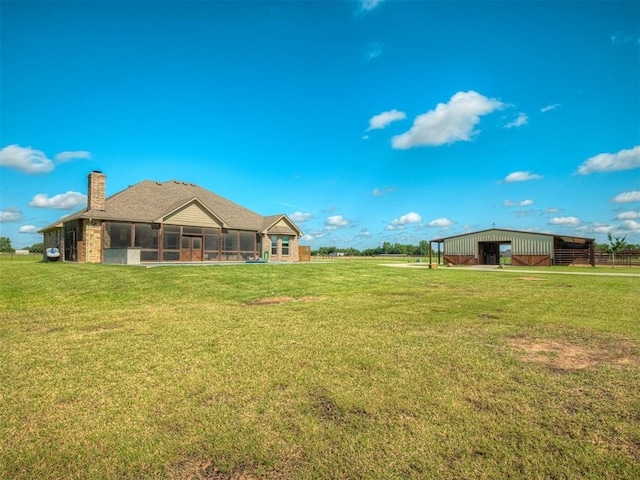 5021 SE 12th Ave, Washington, OK 73093 - view of grassy yard featuring a sunroom, a pole building, and an outbuilding