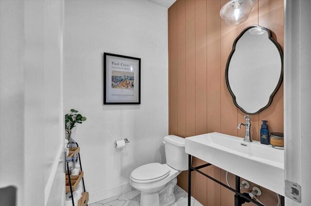 1049 Dorsi Way, Newcastle, OK 73065 - half bath with toilet, baseboards, marble look tiles, and a sink