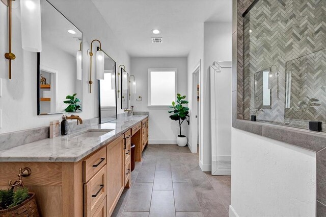 1049 Dorsi Way, Newcastle, OK 73065 - bathroom with double vanity, baseboards, tiled shower, tile patterned floors, and recessed lighting