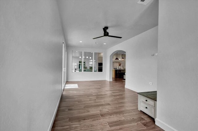 1049 Dorsi Way, Newcastle, OK 73065 - hall featuring arched walkways, wood finished floors, baseboards, and recessed lighting