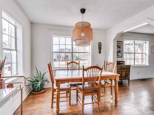 2647 NW 24th St, Oklahoma City, OK 73107 - dining room featuring hardwood / wood-style flooring, baseboards, and arched walkways