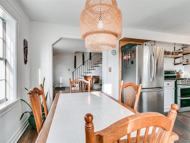 2647 NW 24th St, Oklahoma City, OK 73107 - dining room with a chandelier, stairs, wood finished floors, and healthy amount of natural light