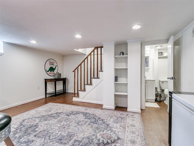 2647 NW 24th St, Oklahoma City, OK 73107 - finished basement with wood finished floors, stairs, recessed lighting, crown molding, and baseboards