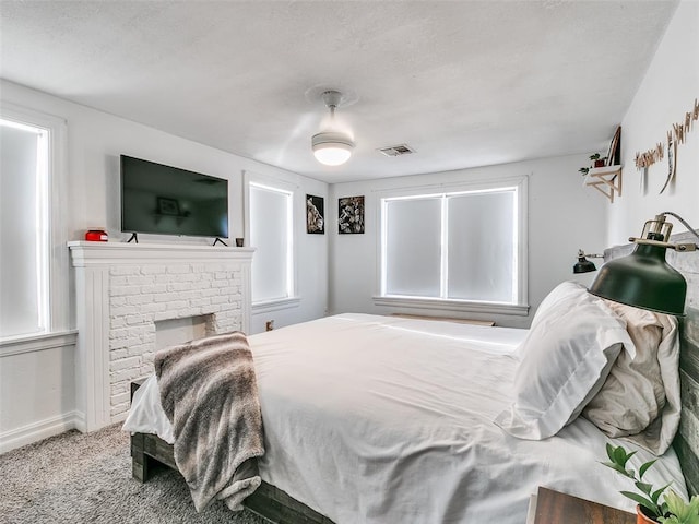 2647 NW 24th St, Oklahoma City, OK 73107 - carpeted bedroom with baseboards and a fireplace