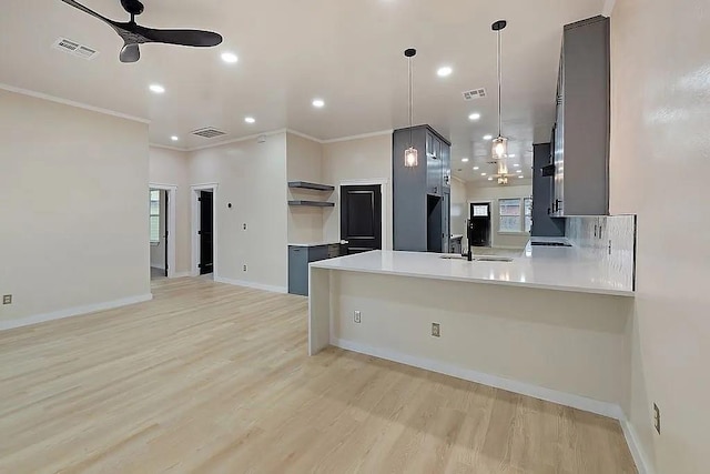 1533 NE 26th St, Oklahoma City, OK 73111 - kitchen with ceiling fan, a peninsula, light wood-style flooring, open shelves, and light countertops