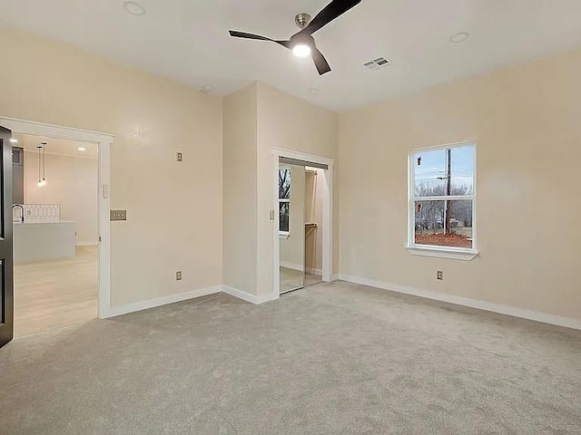 1533 NE 26th St, Oklahoma City, OK 73111 - unfurnished bedroom with light carpet, ceiling fan, and a closet