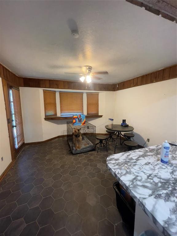8228 NW 90th Ter, Oklahoma City, OK 73132 - dining room with a ceiling fan and dark tile patterned floors