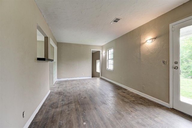 4110 SE 11th St, Oklahoma City, OK 73115 - spare room with wood finished floors, a textured ceiling, and a textured wall
