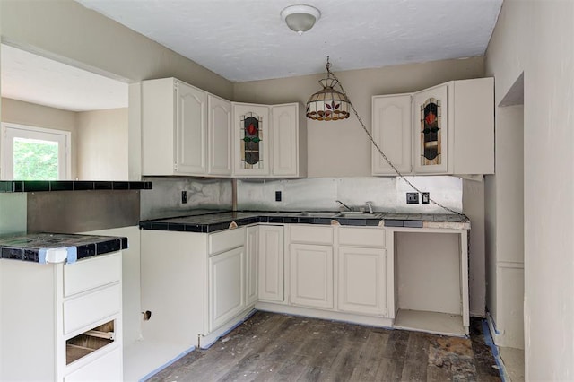 4110 SE 11th St, Oklahoma City, OK 73115 - kitchen with glass insert cabinets, backsplash, wood finished floors, white cabinetry, and tile counters