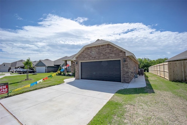 14128 Hamlet Way, Piedmont, OK 73078 - view of front of property with brick siding, central air condition unit, driveway, and an attached garage