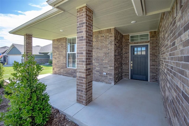 14128 Hamlet Way, Piedmont, OK 73078 - doorway to property featuring brick siding