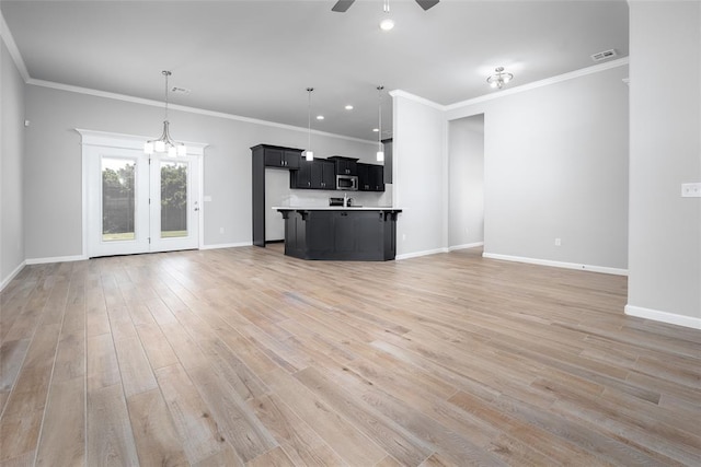 14128 Hamlet Way, Piedmont, OK 73078 - unfurnished living room with a ceiling fan, baseboards, light wood finished floors, crown molding, and recessed lighting