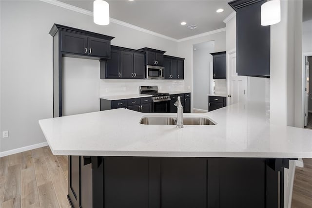 14128 Hamlet Way, Piedmont, OK 73078 - kitchen with stainless steel appliances, a sink, ornamental molding, dark cabinets, and recessed lighting