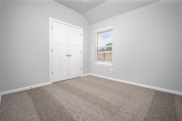 14128 Hamlet Way, Piedmont, OK 73078 - unfurnished bedroom with lofted ceiling, carpet floors, baseboards, and a closet