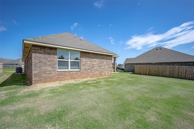 14128 Hamlet Way, Piedmont, OK 73078 - rear view of house featuring central AC, brick siding, and a shingled roof