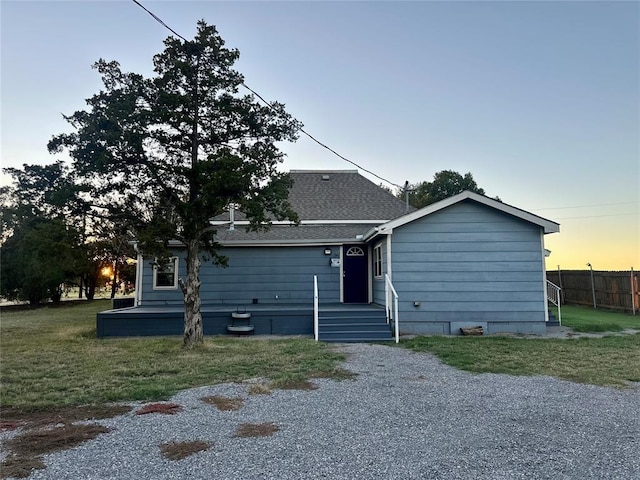 20973 US Highway 62, Altus, OK 73521 - back of house at dusk with a yard and roof with shingles