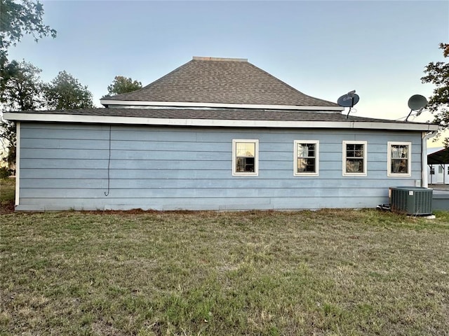 20973 US Highway 62, Altus, OK 73521 - view of side of home featuring central AC, a yard, and roof with shingles