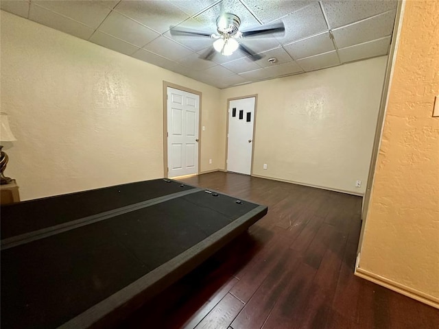 20973 US Highway 62, Altus, OK 73521 - playroom featuring a textured wall, a paneled ceiling, dark wood finished floors, a ceiling fan, and baseboards