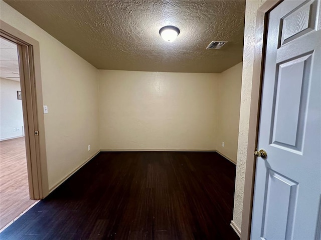 20973 US Highway 62, Altus, OK 73521 - empty room with wood finished floors and a textured ceiling
